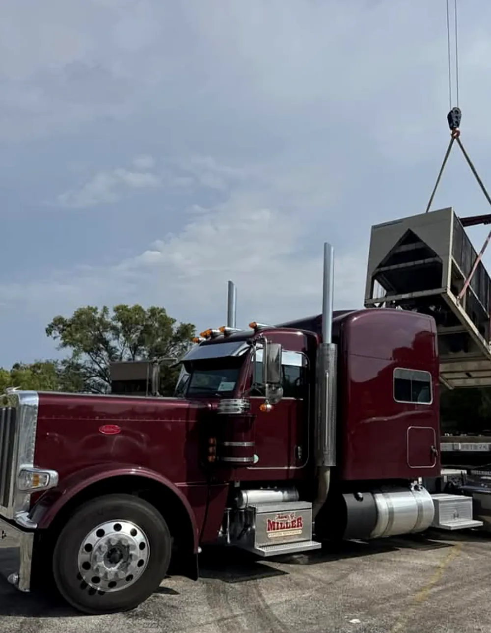 Tank being lifted onto a Travis G. Miller truck
